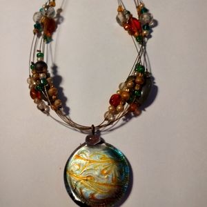 Amazing necklace, with colourful beads and beautiful stone at centre.